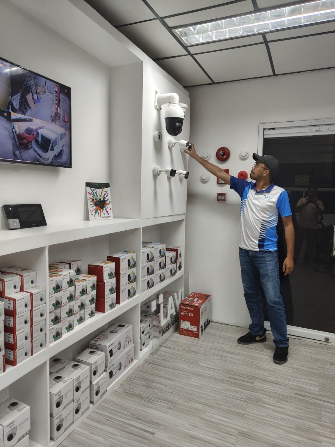 LAVI Technologies technician inspecting CCTV equipment in the company showroom