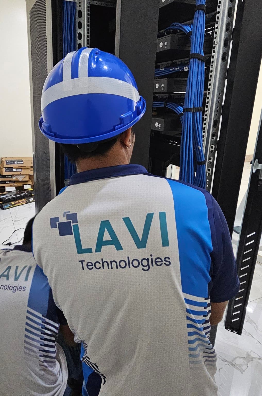LAVI technician working at the EMB R9 network rack