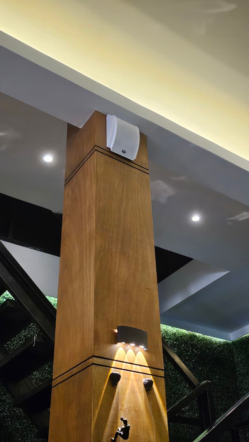 Indoor wall speaker mounted near an architectural column