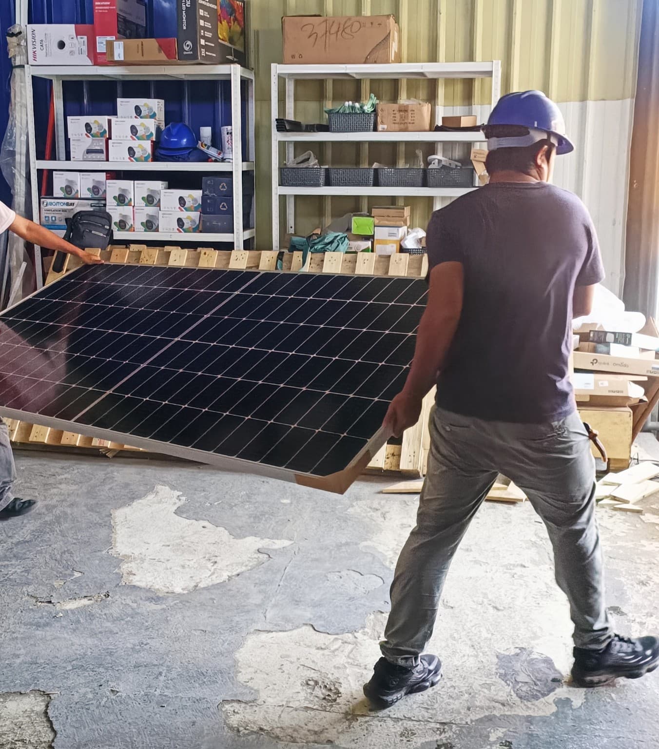 Team carrying a solar panel during installation