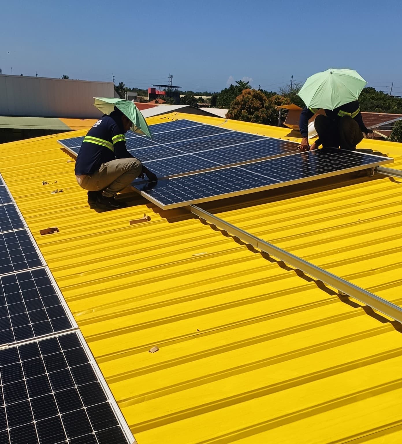 Installers working on rooftop solar panel installation
